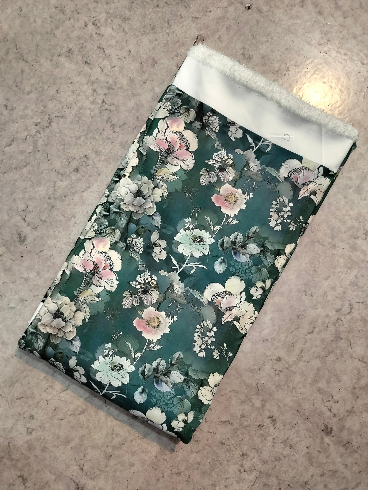 Teal and mint floral BSY dress material folded into a cut piece