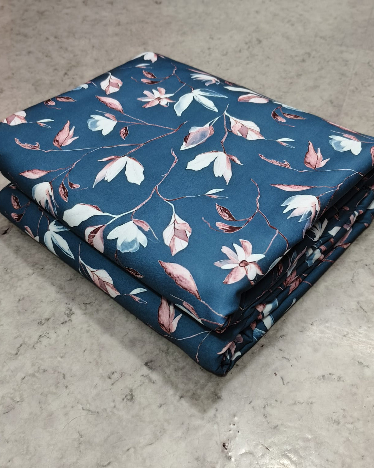 Grey floral micro crepe fabric showing texture and drape
