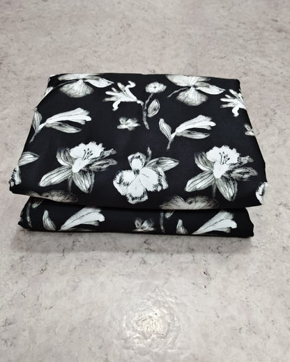 Black and white floral micro crepe fabric shown full width