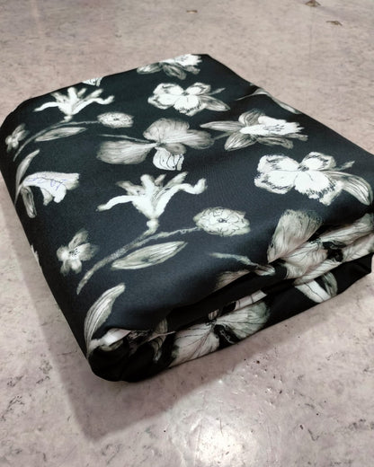 Black floral micro crepe dress material folded into a cut piece