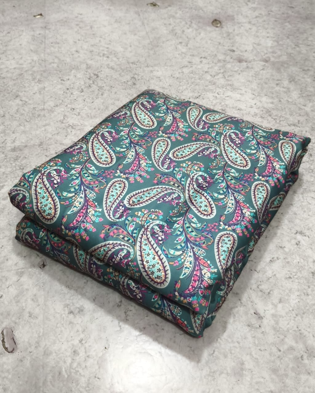 Teal paisley moss fabric texture in close up