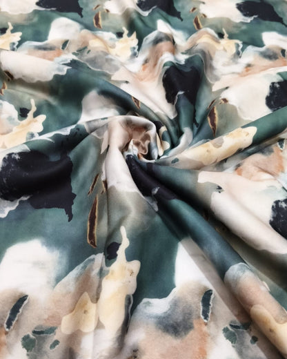 Watercolour abstract moss dress material folded into a cut piece