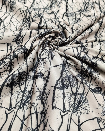 Close detail of the fine black branch motif on cream moss
