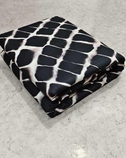Geometric printed micro crepe dress material folded into a cut piece