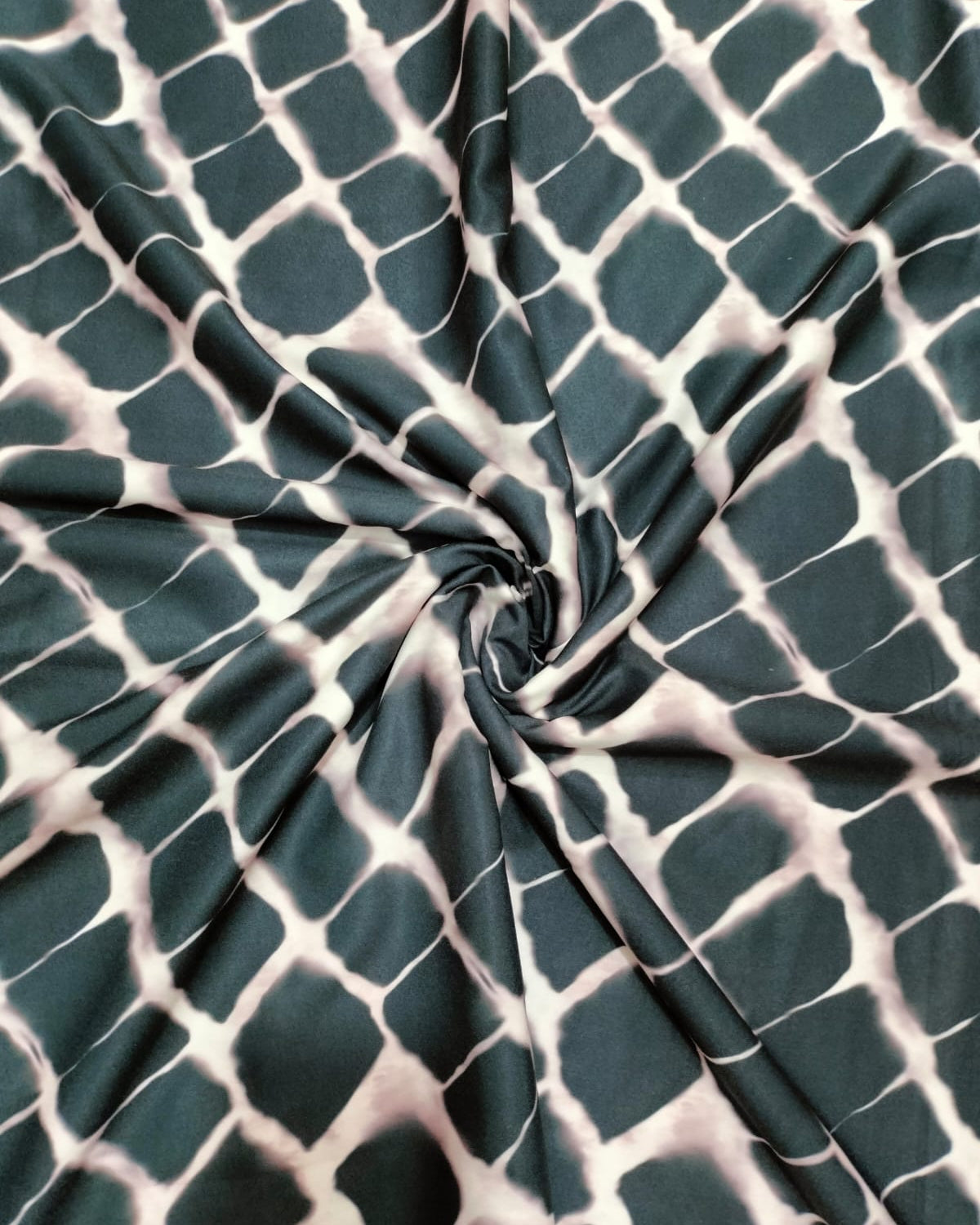 Close detail of the black and white grid print on micro crepe