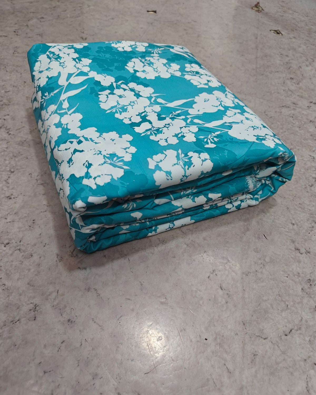 Teal and white blossom micro crepe fabric in close up