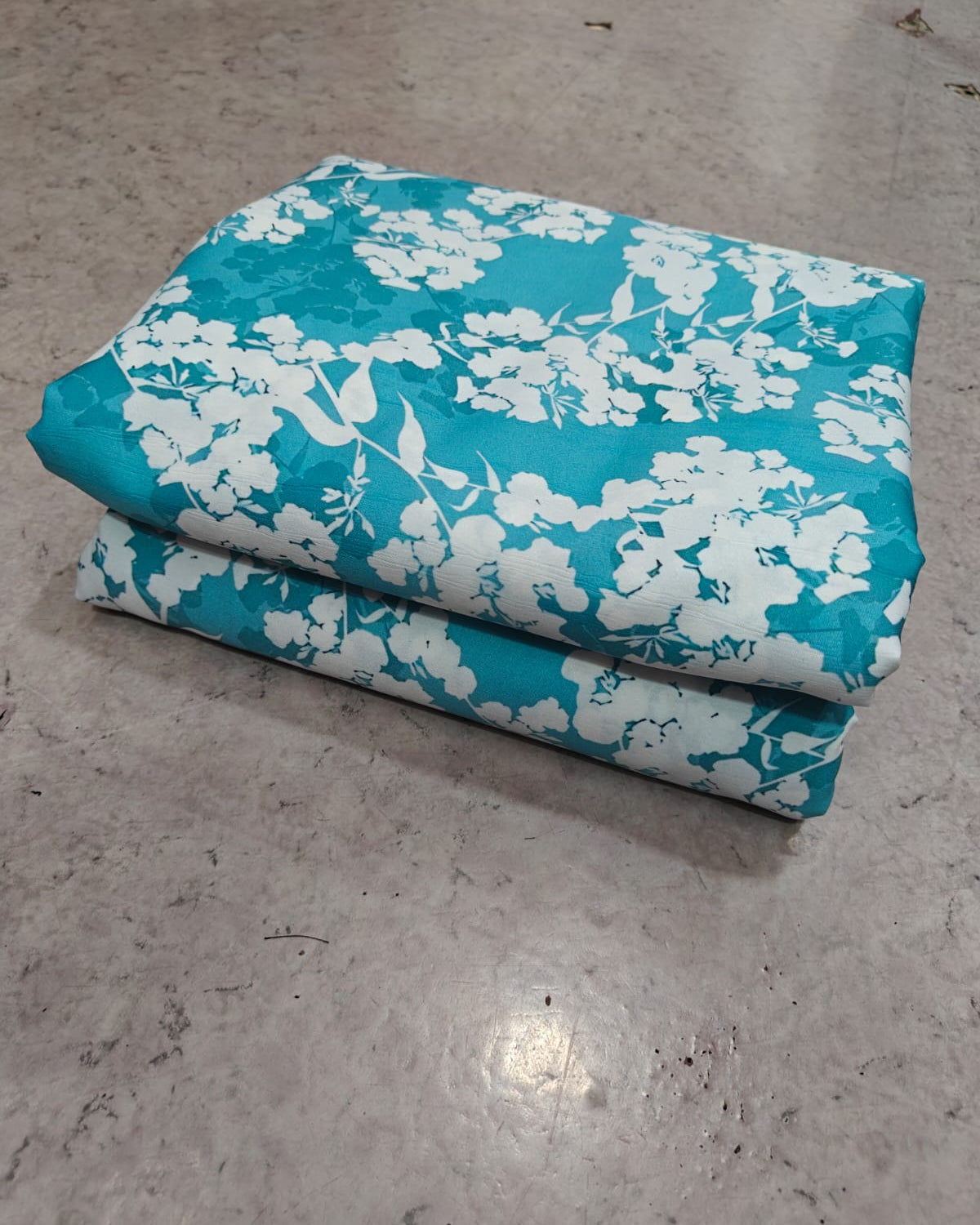 Teal and white blossom micro crepe showing texture and drape
