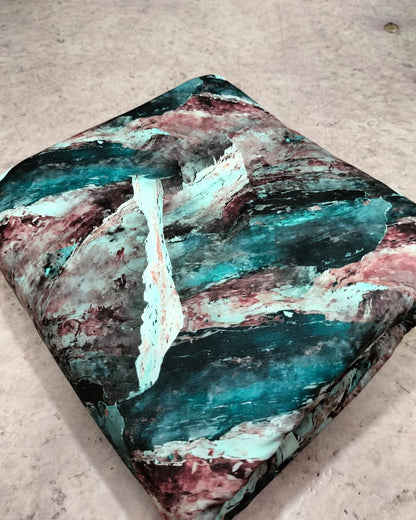 Teal and pink abstract micro crepe dress material folded into a cut piece