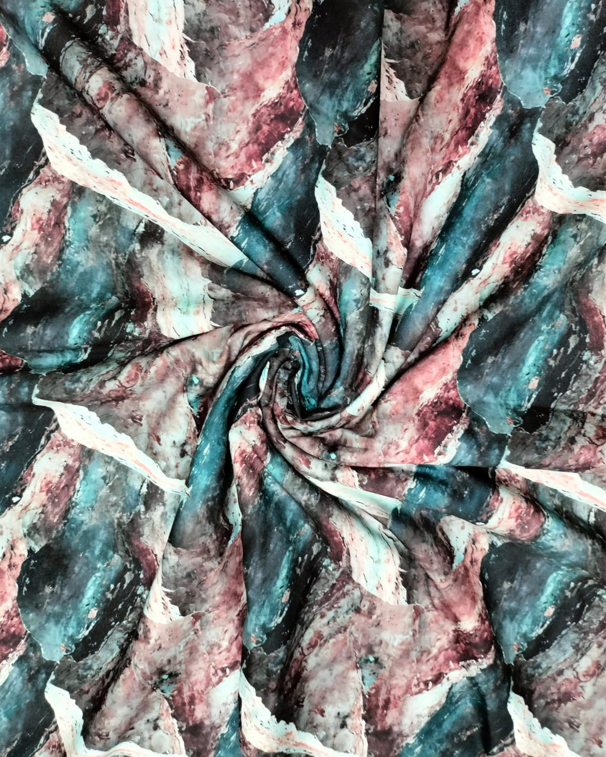 Teal and pink marble micro crepe fabric showing drape