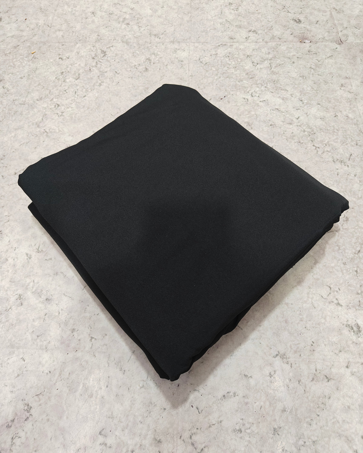 Black micro crepe fabric showing drape and fall